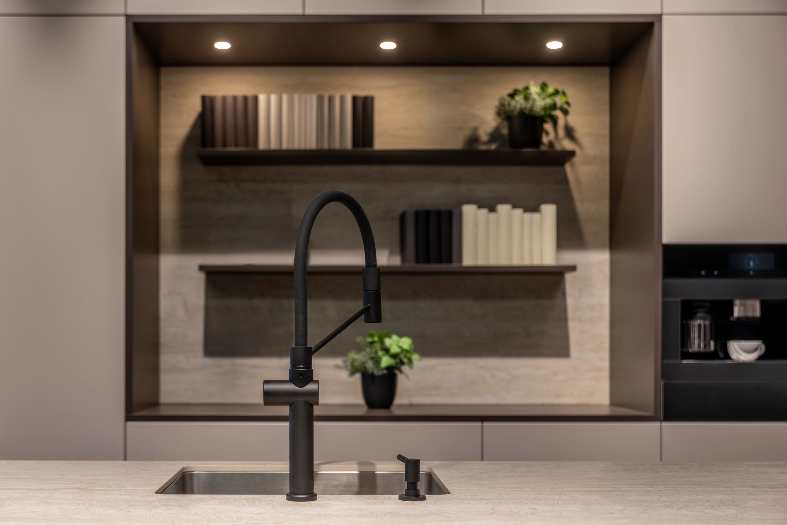 Contemporary kitchen with stone countertop and matte black faucet